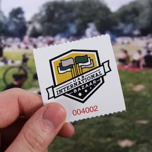 2x2 admission ticket to a community market event for a university. The ticket features the event's logo and red numbering on a simple white background