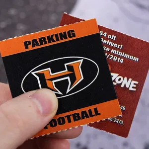 2x2 roll tickets for parking at a football game. The backside features a coupon for a local business