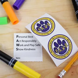 2x2 PBIS tickets for elementary schoolers with a paw print graphic. The backside has a space for the child to fill in their name