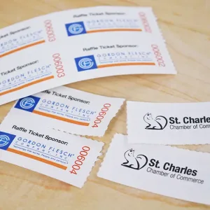 Simple 2x2 coupon-style roll tickets with the raffle's sponsor and host printed clearly on a white background