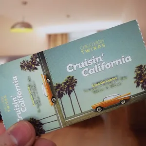 2-Part admission roll tickets to an event at a high school. The design features a classic car in bright orange against a teal sky