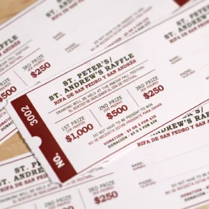 White and red 2x6 raffle roll tickets with prize information and spaces for participants to write their name and phone number