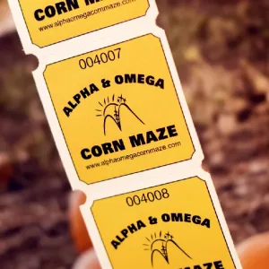 A strip of yellow 2x2 rounded corner roll tickets for a corn maze