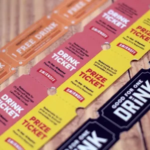 Three varieties of custom drink roll tickets displaying fine text detail and a wide range of vibrant color capability